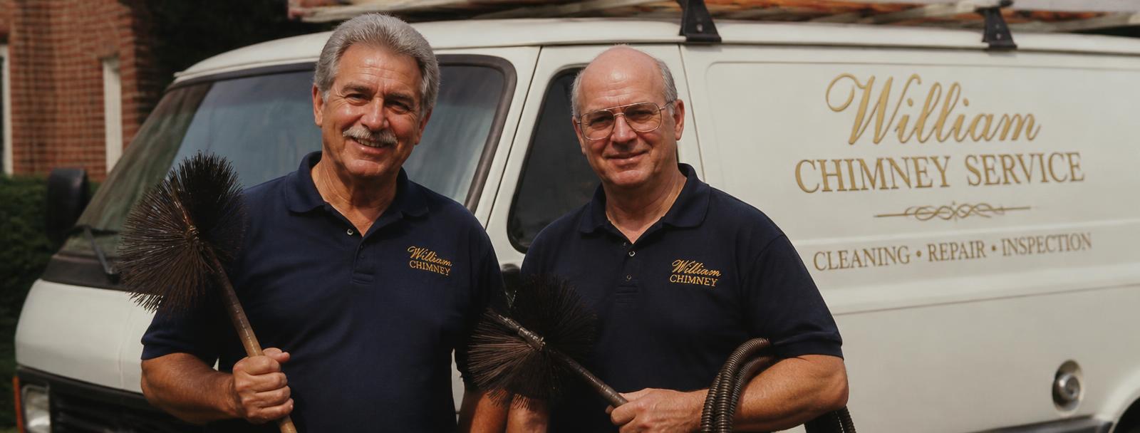 Two experienced William Chimney technicians with their service van